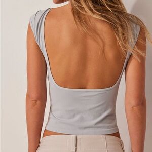 Low-back seamless Tee from free people. Never worn. Size medium. Open back